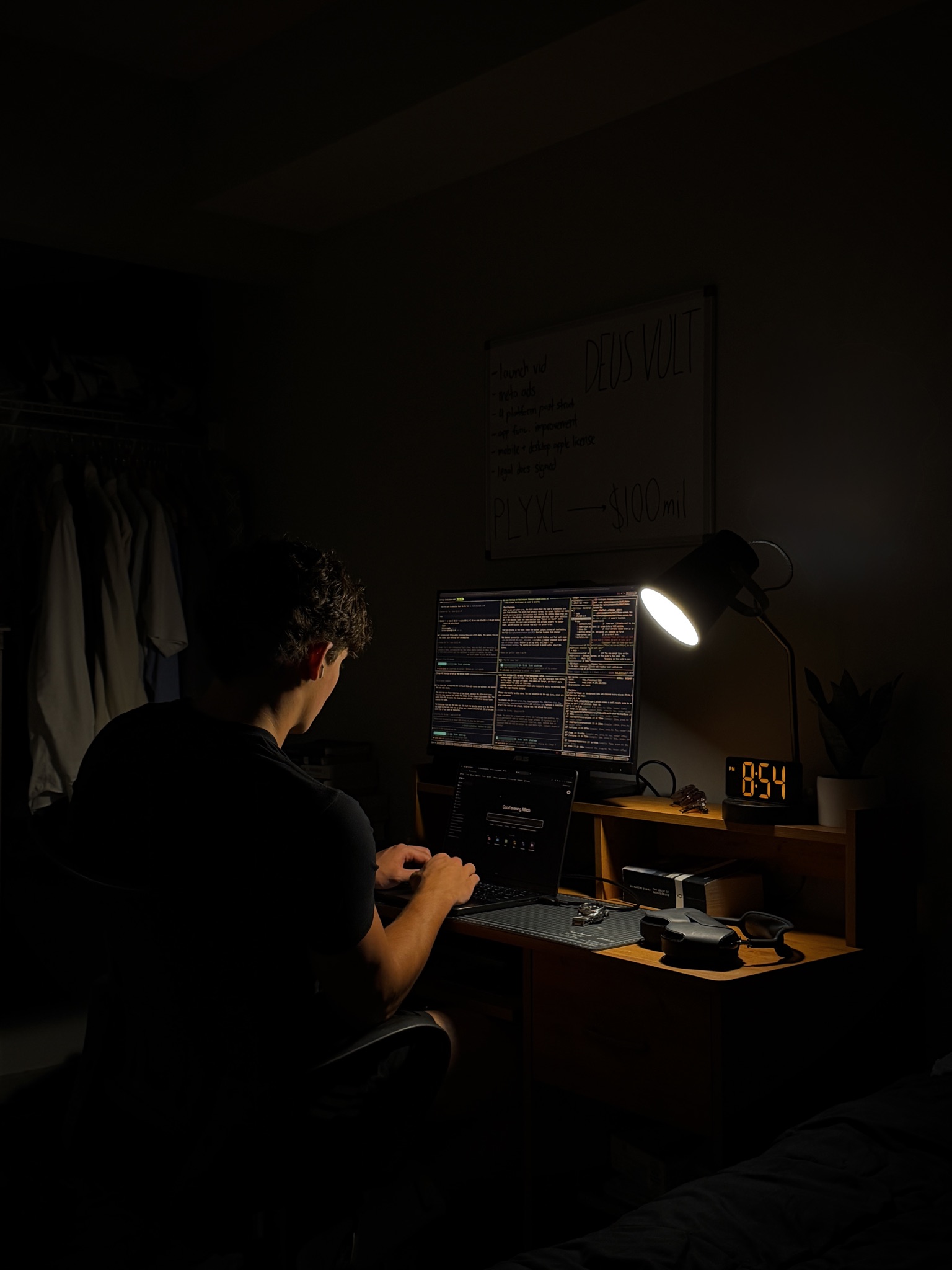 Mitchell working at a desk at night, lit by a desk lamp